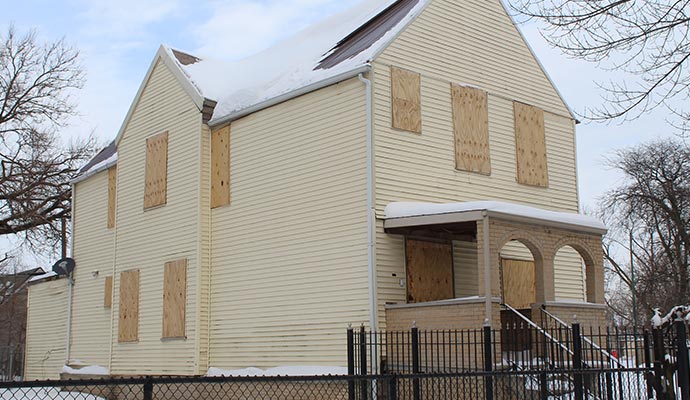 Recovered boarded-up house with disaster restoration.