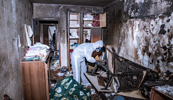 Professional worker restoring a fire damaged room